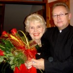 Dr. Jack presenting roses following Kitty's speaking event at Catholic Church in Radom, October 13, 2009